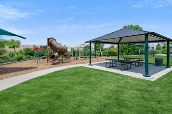 Playground with covered picnic shelter and green lawn